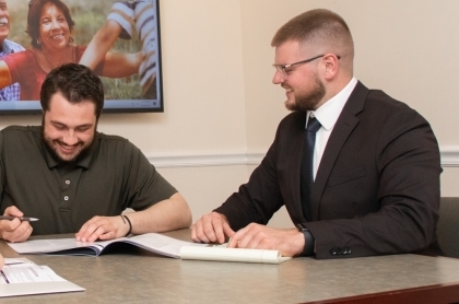 Financial Advisor holding a virtual whiteboard of charts and words about saving.